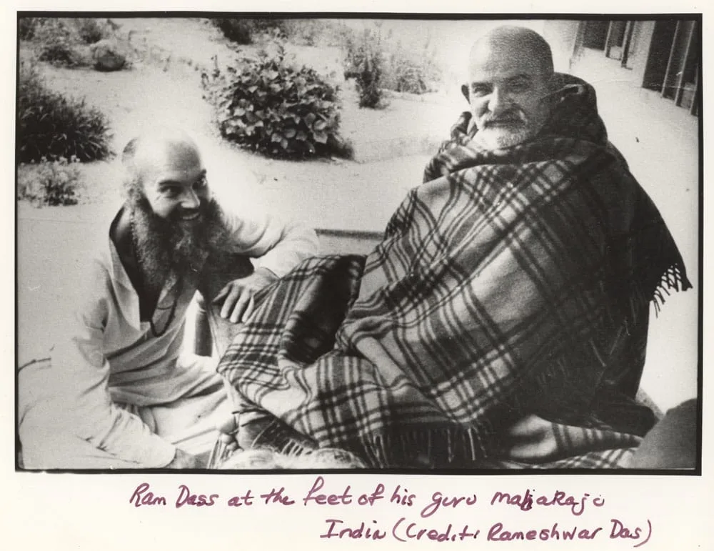 Neeb Karori Baba seated calmly with Ram Dass in India